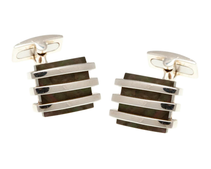 Pair of silver and black striped cufflinks on a white background