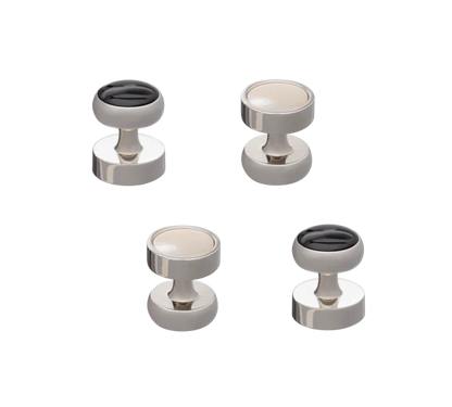 Set of four metallic button studs on a white background