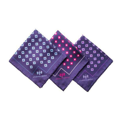 Three purple patterned handkerchiefs on a white background
