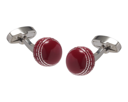 Cufflinks designed like a red cricket ball with silver metal loops on a white background