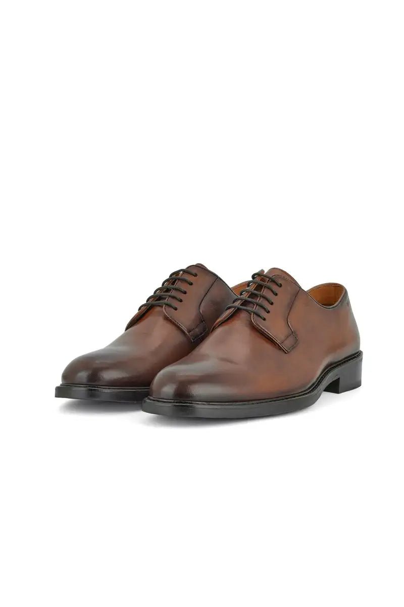 brown dress shoe on white ebackground