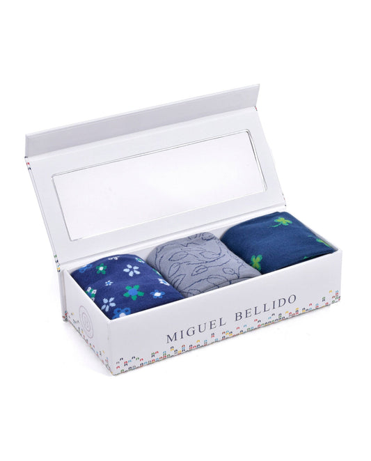 Three pairs of socks in a box with 'Miguel Bellido' branding on a white background