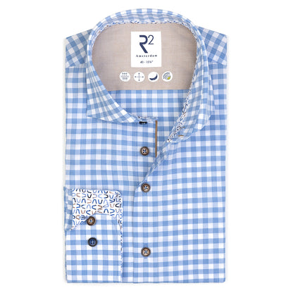 Blue and white checkered shirt with patterned pocket on a white background