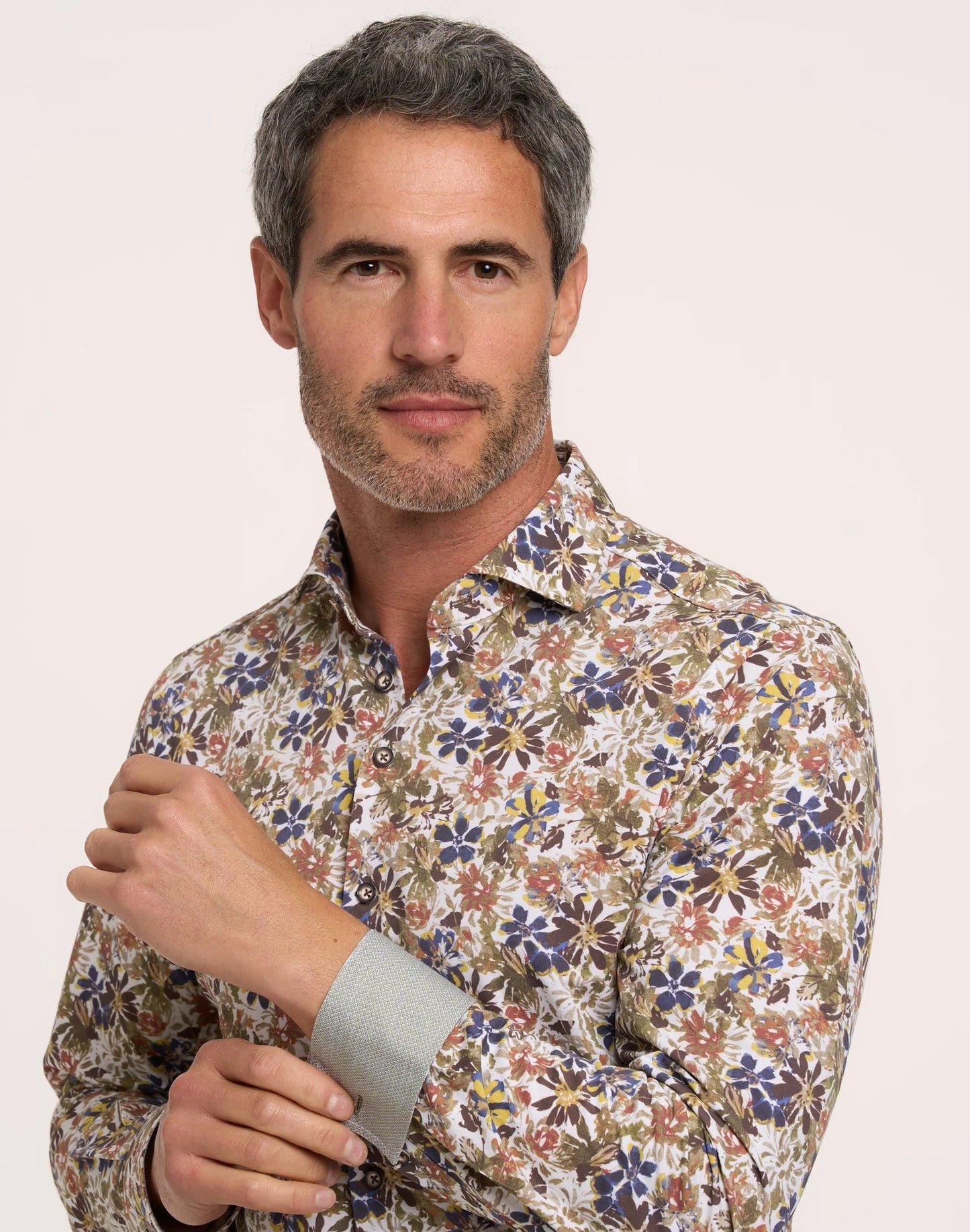 Man wearing a patterned shirt against a plain background