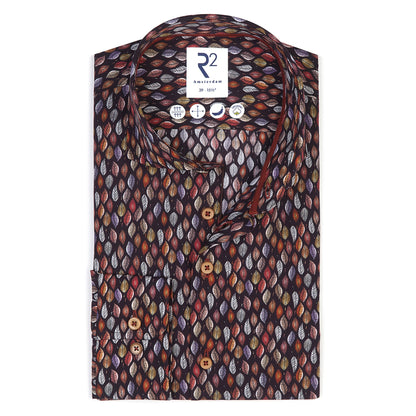 Folded patterned shirt with a brand label on a white background