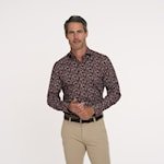 Man wearing a patterned shirt and beige pants on a white background