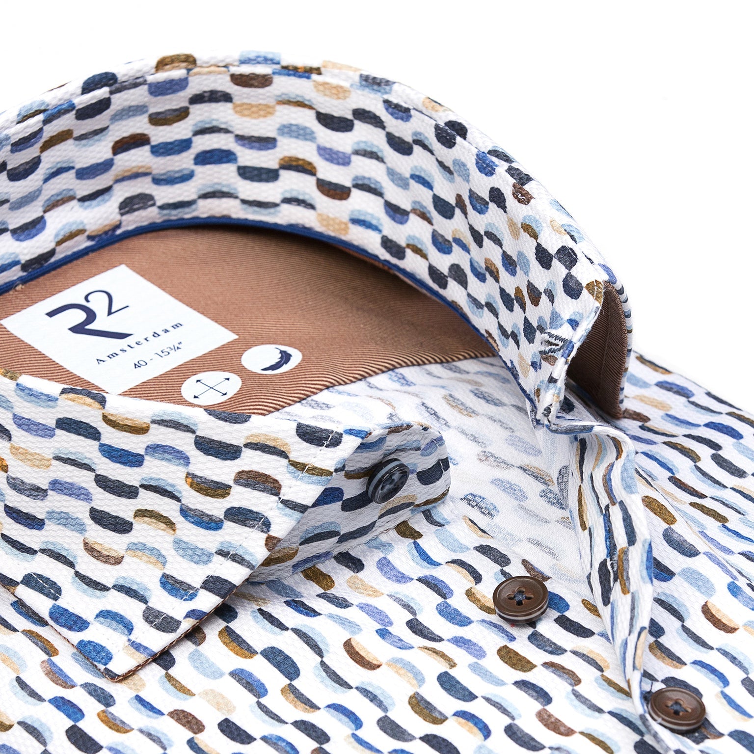 Close-up of a patterned shirt with a brand label on a white background