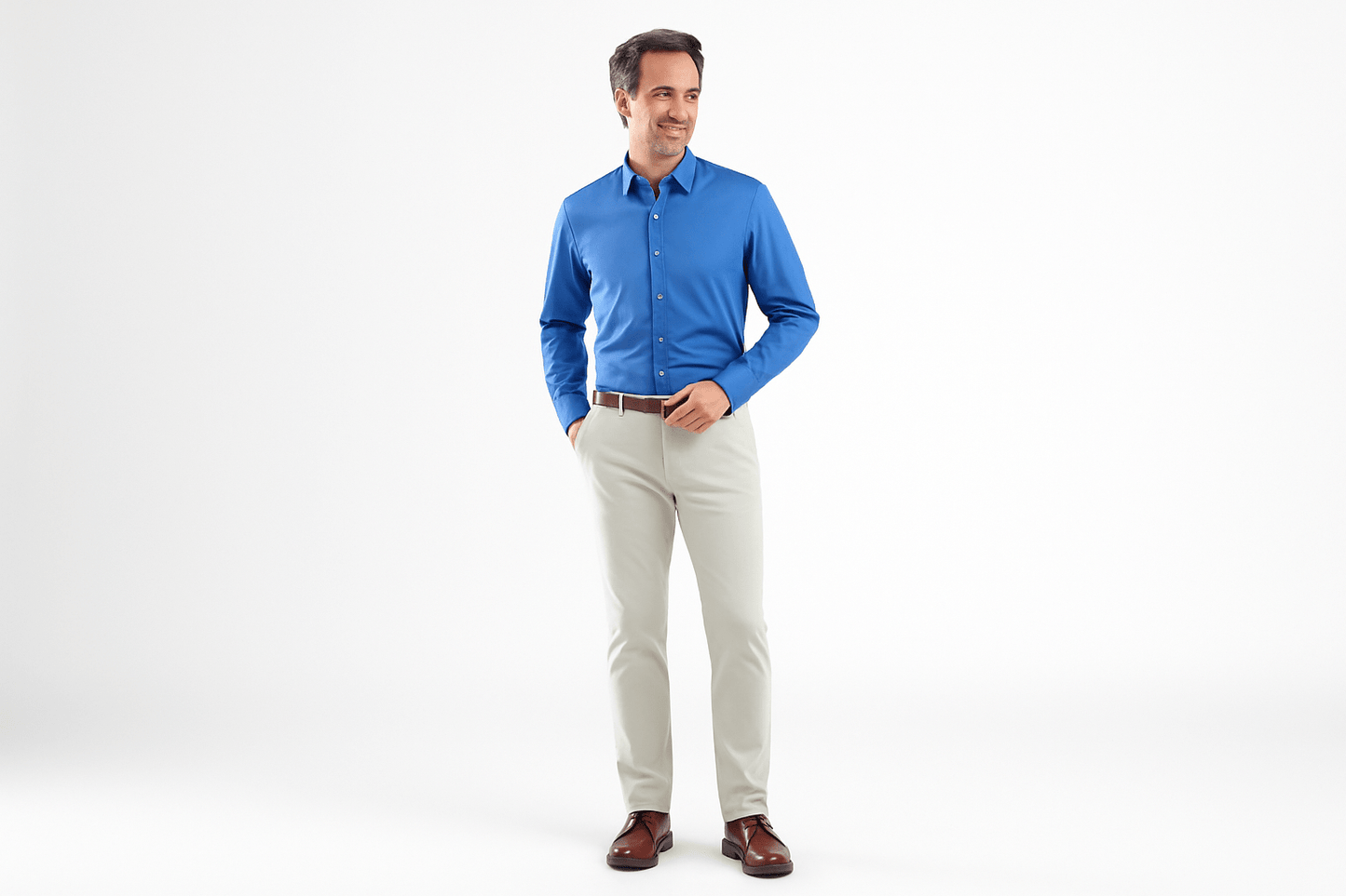 Man wearing a blue shirt and beige pants on a white background