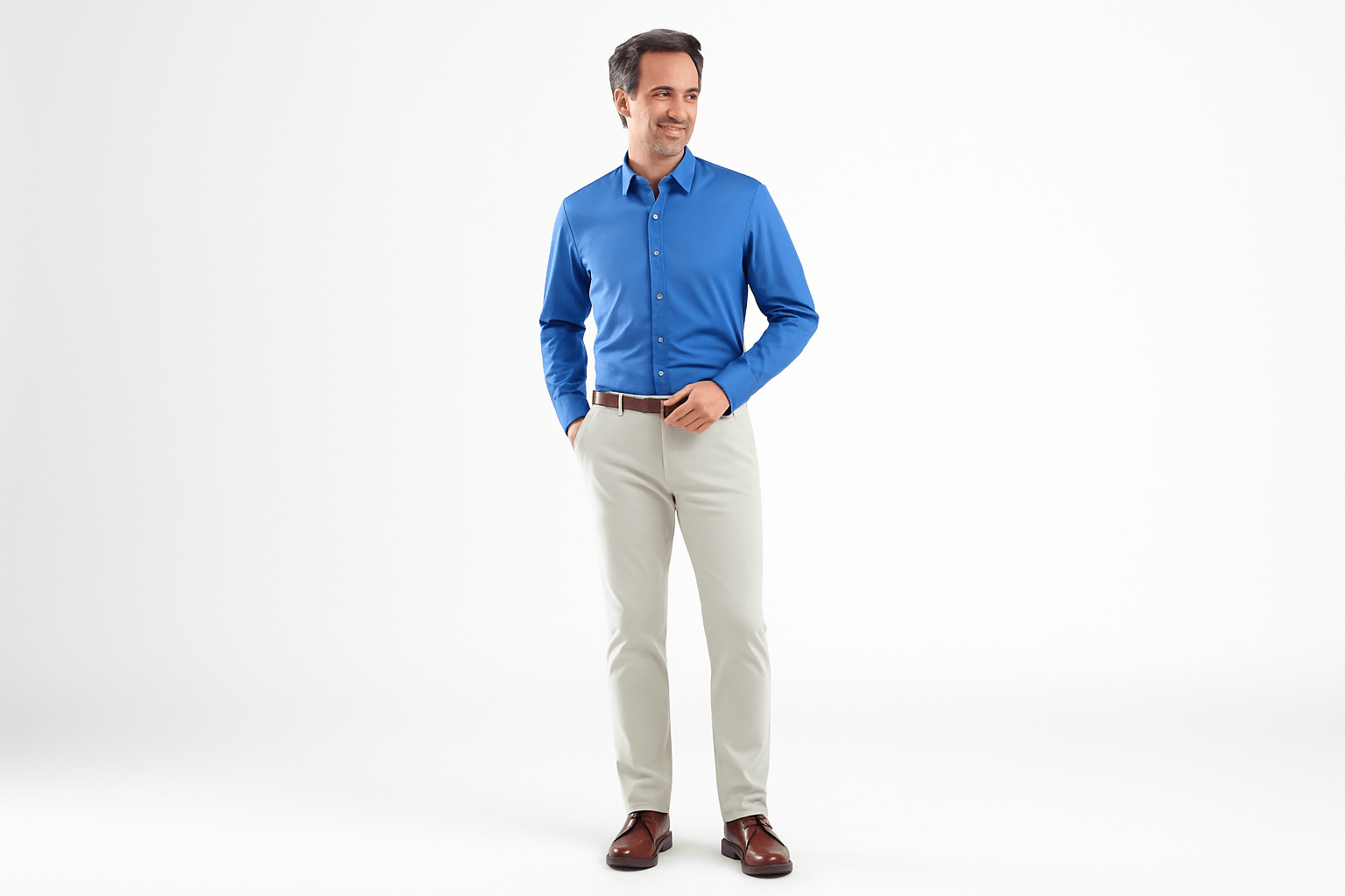 Man wearing a blue shirt and beige pants on a white background