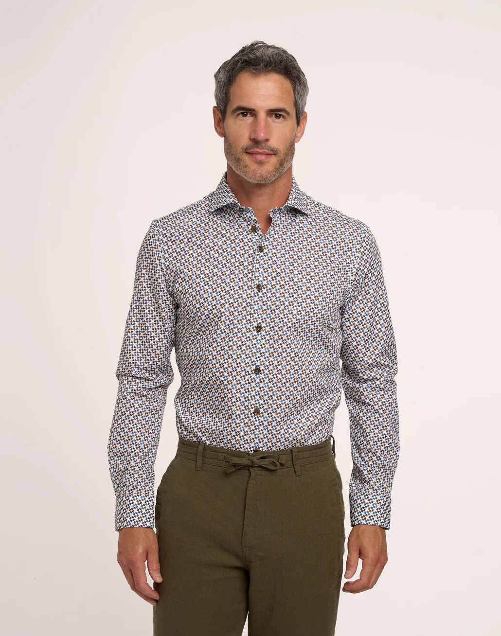 man in print dress shirt on white background