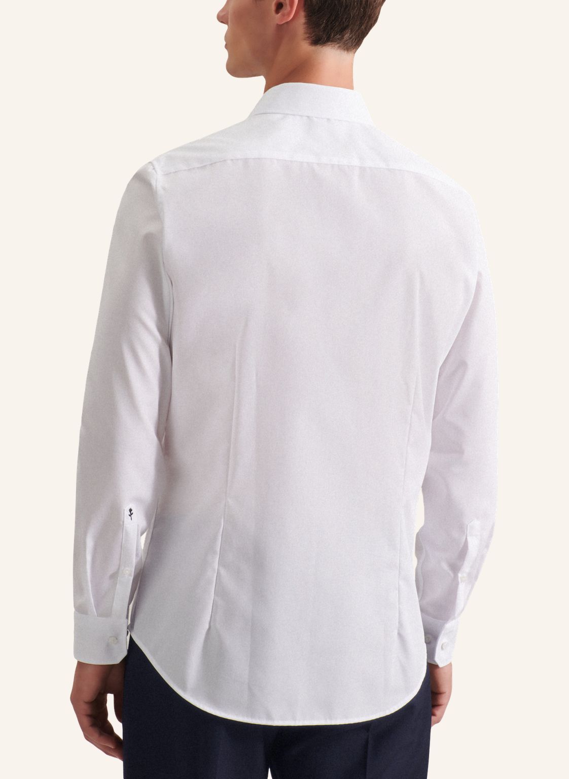 White dress shirt worn by a person on a white background