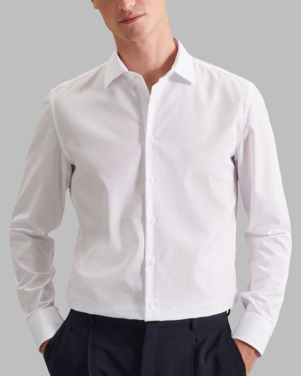 White dress shirt worn by a person on a gray background