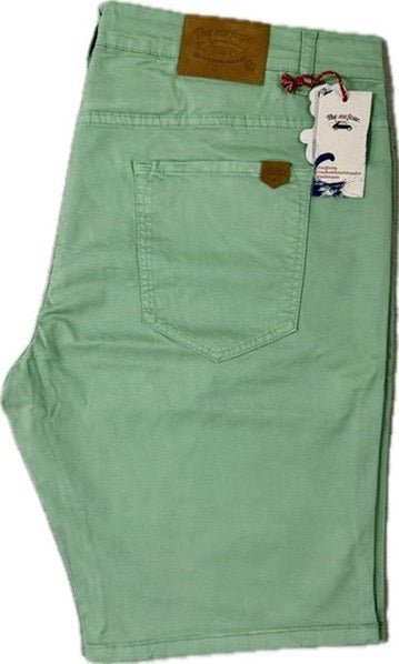 Green pants with a tag on a white background
