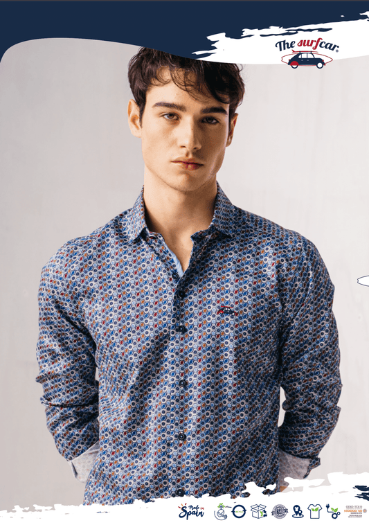 Man wearing a patterned shirt against a plain background with 'The Suvar' branding.