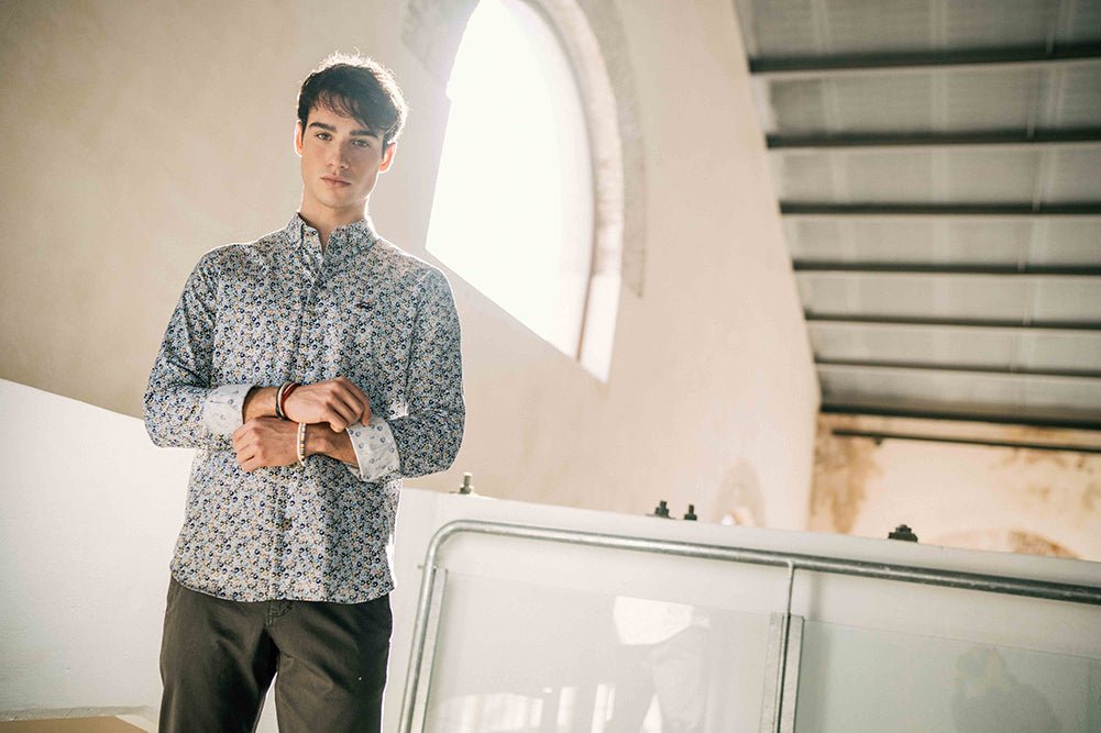 Man standing next to a car with a modern architectural background