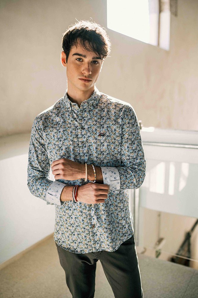 Man wearing a patterned shirt in an indoor setting