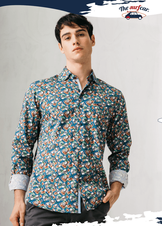 Man wearing a patterned shirt with a plain background